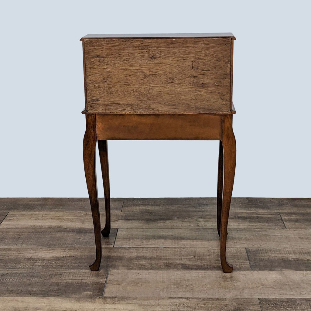 Back view of Ethan Allen desk showing its wooden finish and elegant legs.