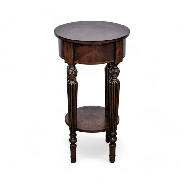 Round Reperch side table with inlaid wood top and ornate fluted legs on white background.