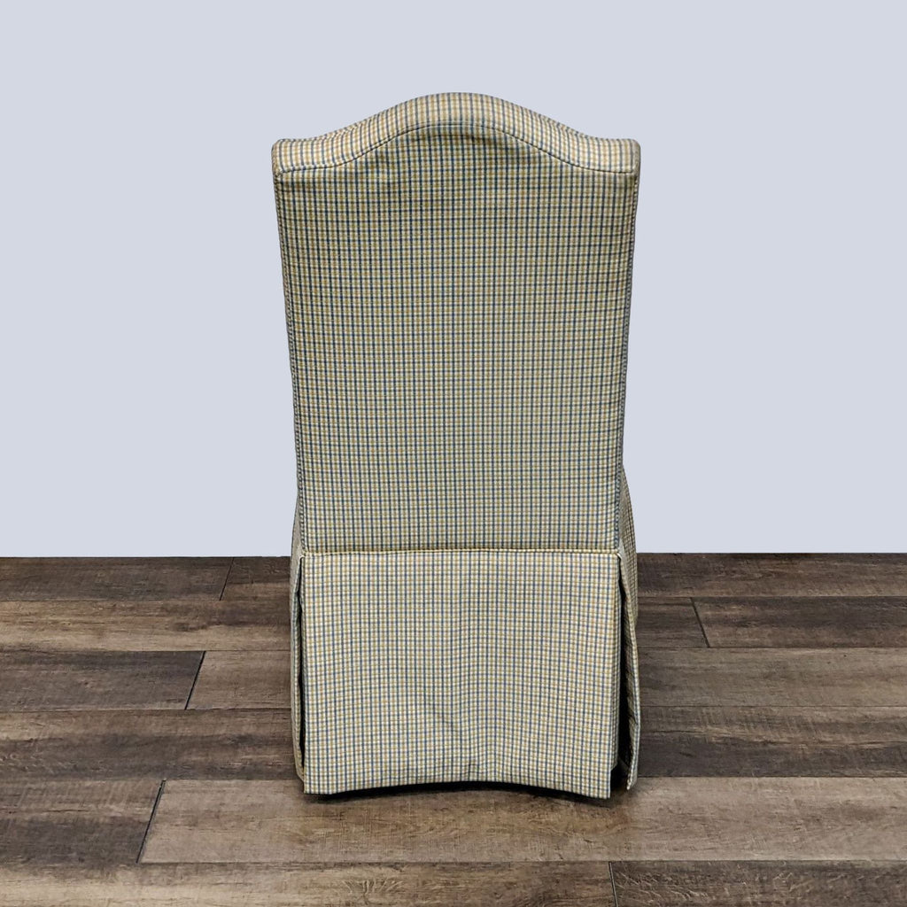 Ethan Allen skirted hostess dining chair with high back and checkered upholstery, rear view.