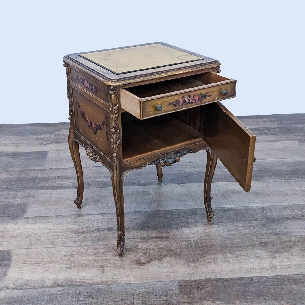 End table with open drawer revealing storage, showcasing intricate floral carvings and gold mirror top, by Reperch.