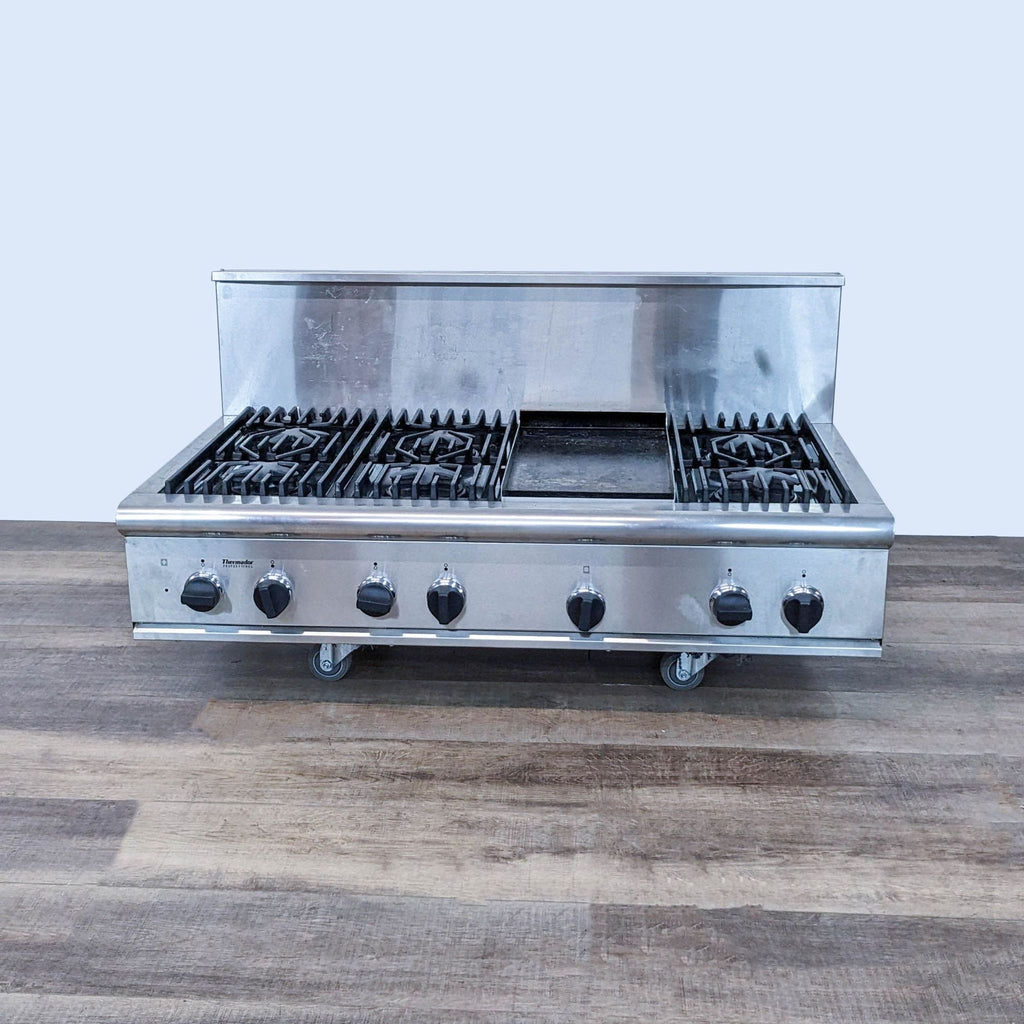 1. Stainless steel Thermador Professional Gas Range with multiple burners, griddle insert, and control knobs on a wooden floor.