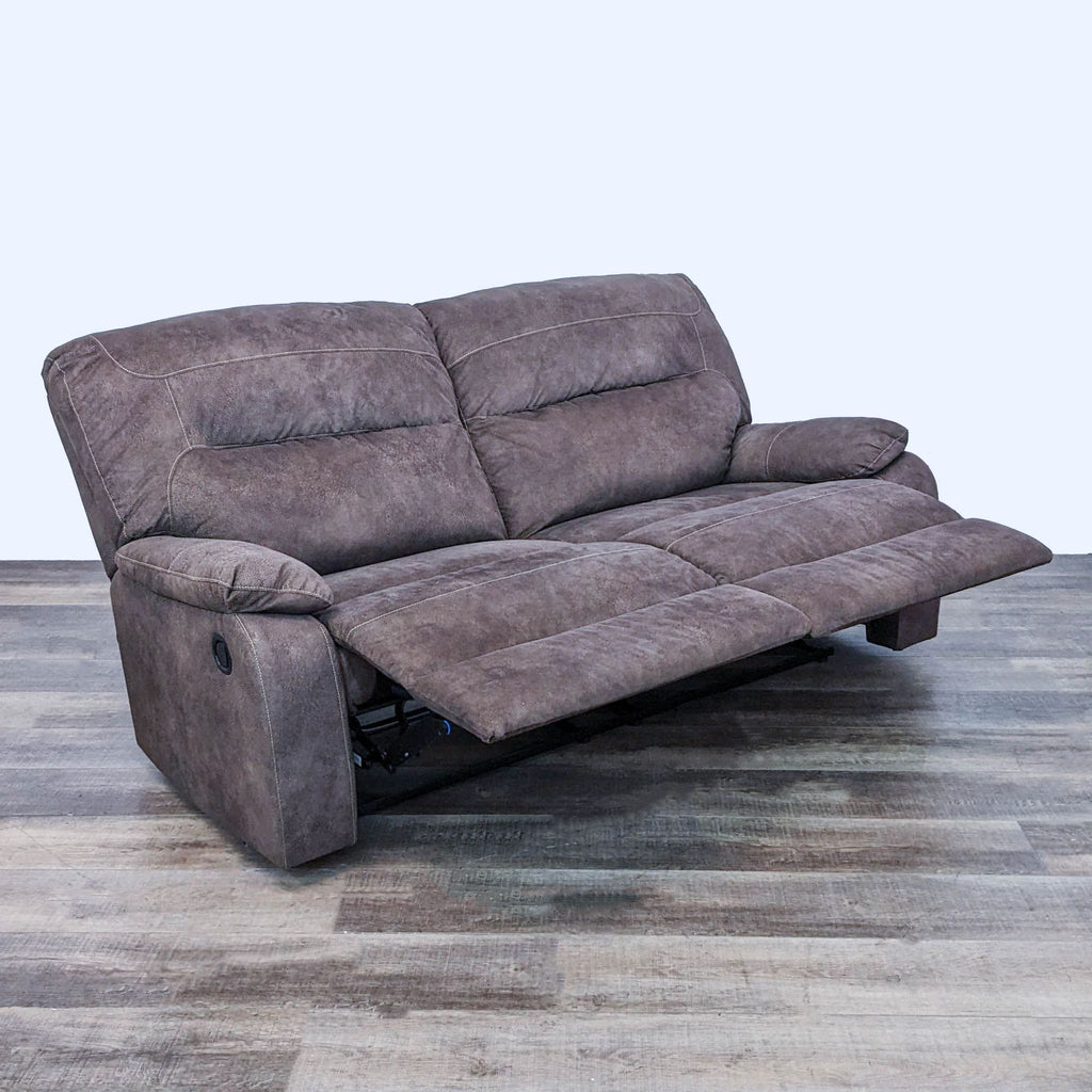 2. Ashley Furniture's Bolzano loveseat in reclined position, showcasing pull-tab mechanism, coffee brown microfiber.
