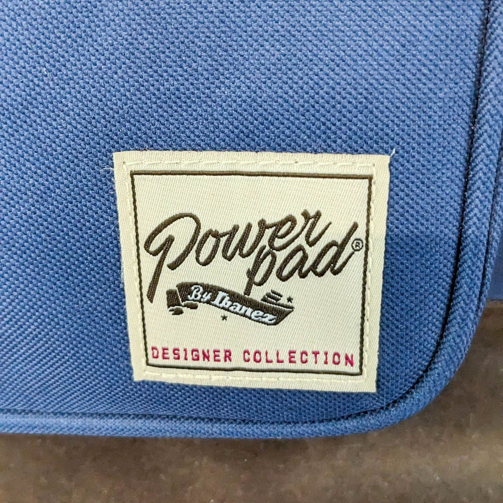 Blue padded gig bag with "Powerpad by Ibanez - Designer Collection" label, for guitar storage and transport.