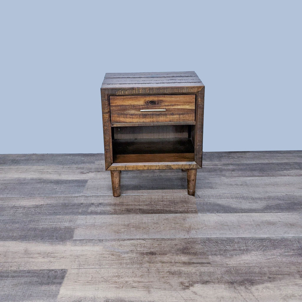 Mid-century nightstand with tapered legs, rustic finish, and single drawer by Ashley Furniture.