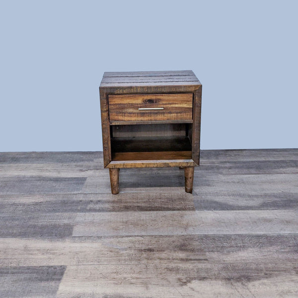 Mid-century nightstand with tapered legs, rustic finish, and single drawer by Ashley Furniture.
