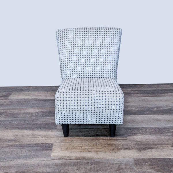 1. EQ3 modern slipper chair with black and white geometric print and angled wooden legs, shown from the front.
