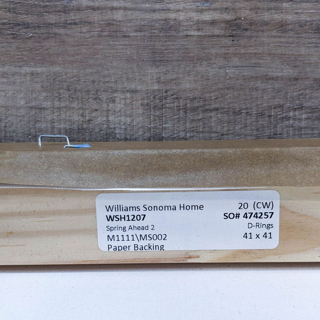 2. "Close-up of a label on a framed artwork by Wendover Art Group for Williams Sonoma Home, detailing the title and dimensions."