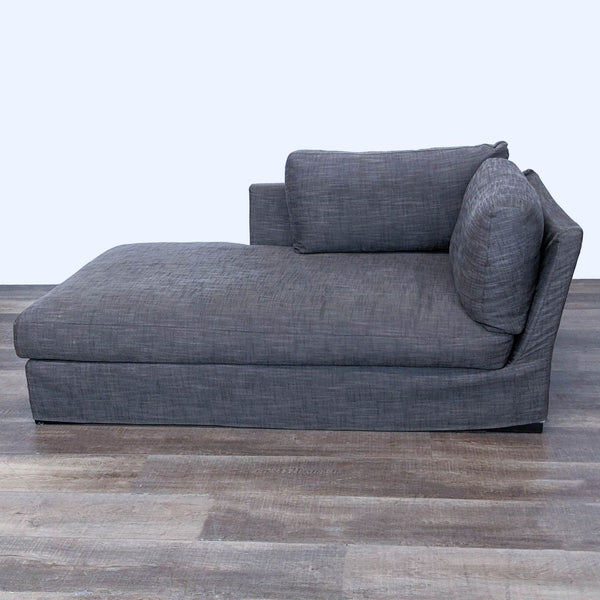 1. Meridiani chase lounge sofa with gray slipcovered upholstery and a side pillow on wood flooring.
