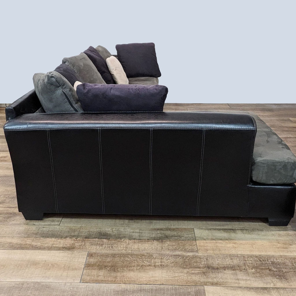 Side view of the Jacurso sectional by Ashley Furniture, showcasing pleather sides and plush microfiber seat cushions.