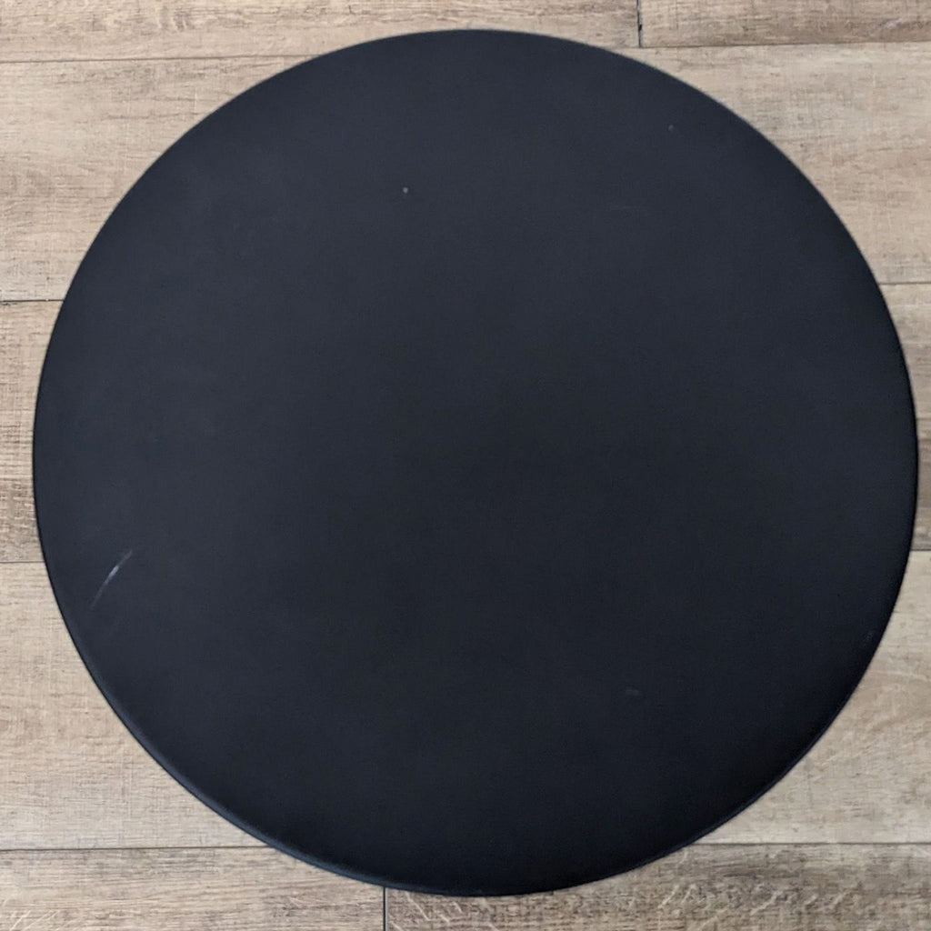 Top view of the Narro side table's black round surface.