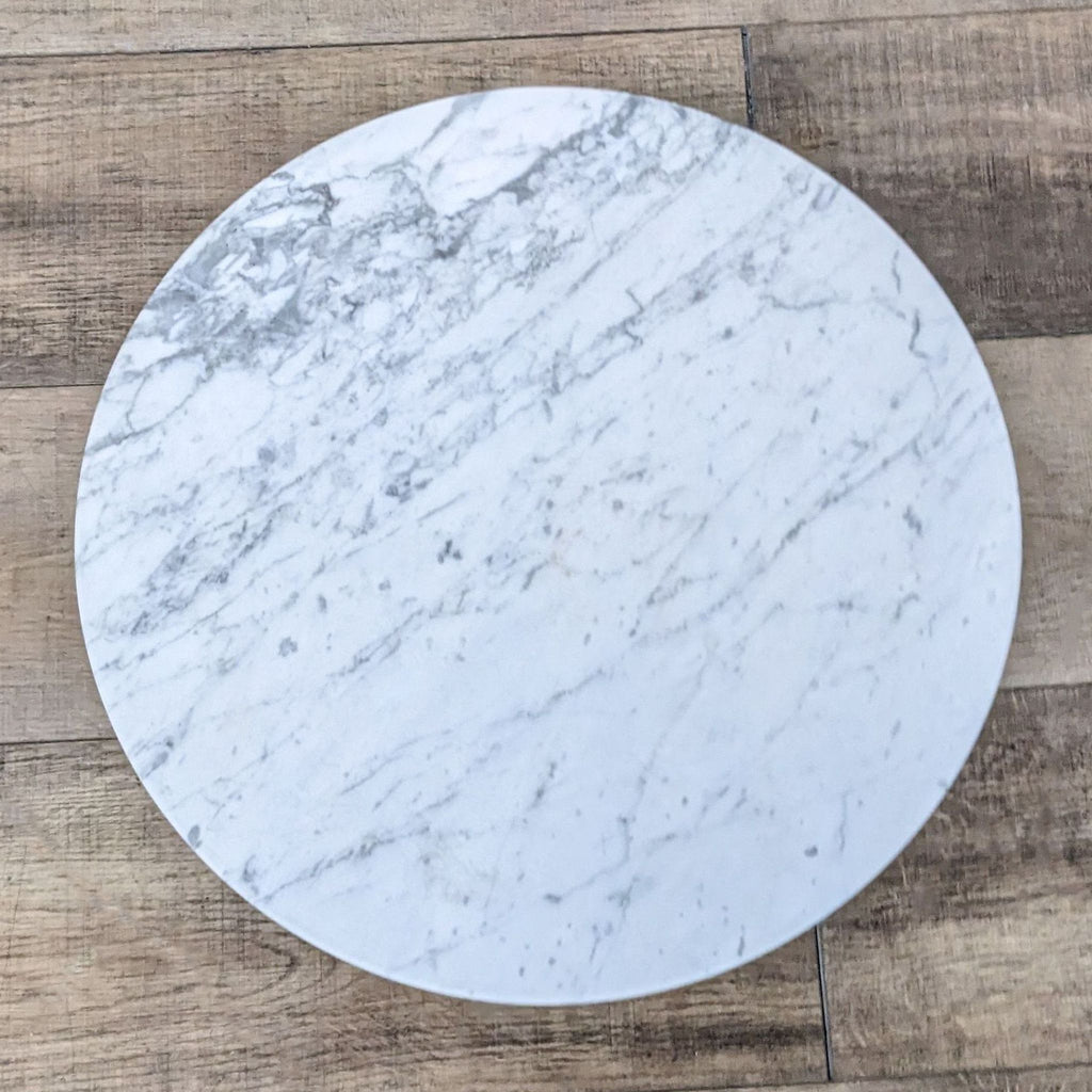 Top view of a white marble tabletop with subtle gray veining.