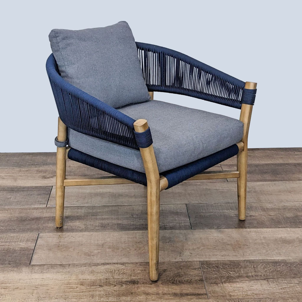 2. Side view of an Article lounge chair featuring a solid acacia wood frame, woven navy rope, and detachable gray cushions.