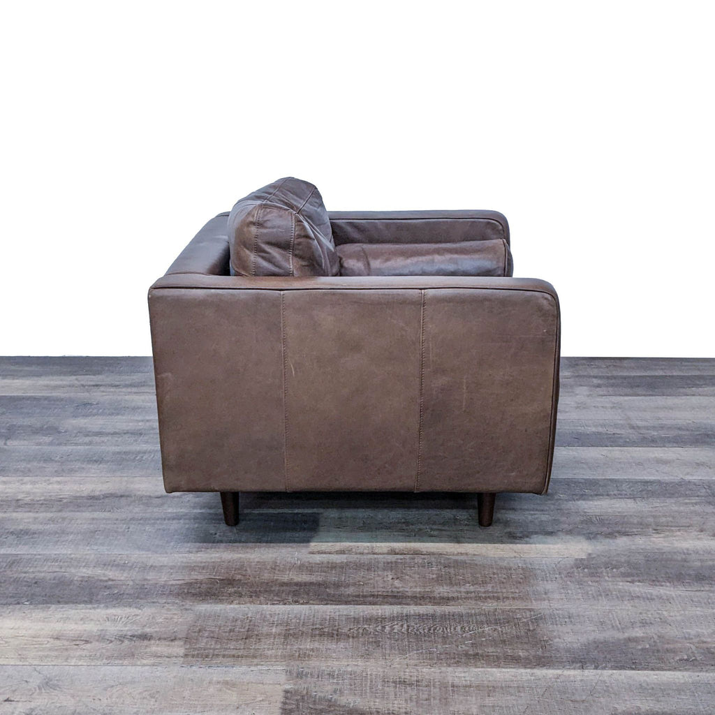 2. Rear view of the Sven leather lounge chair by Article showing clean lines and the back of the tufted, comfy design.
