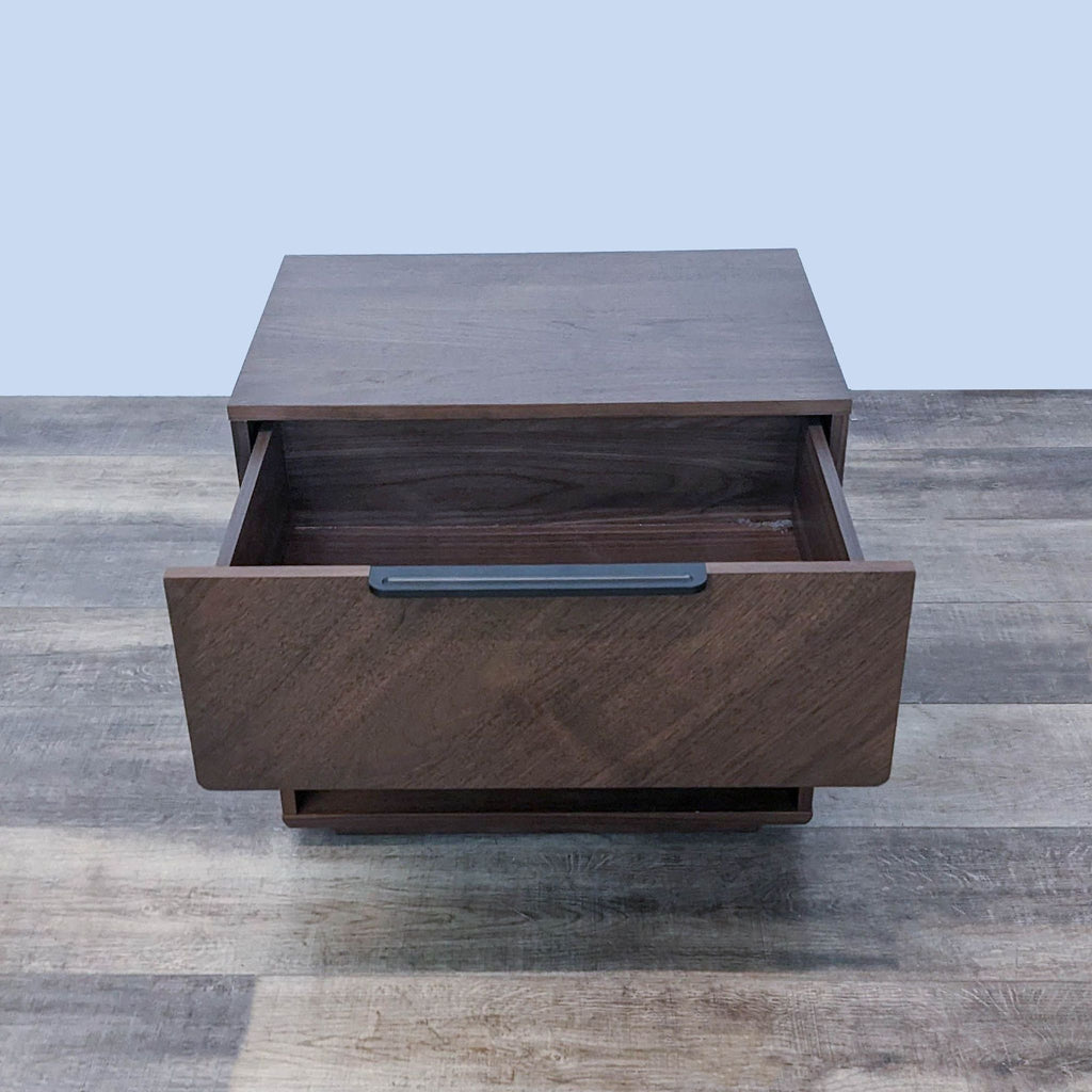 Open drawer on Article brand wooden end table showcasing interior and metal handle.
