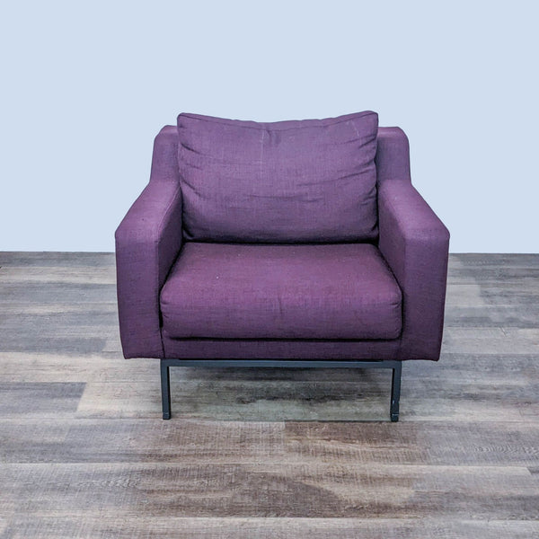 1. EQ3 brand modern lounge chair with plush deep seat and mahogany wood legs, upholstered in Plum fabric, on a wooden floor.