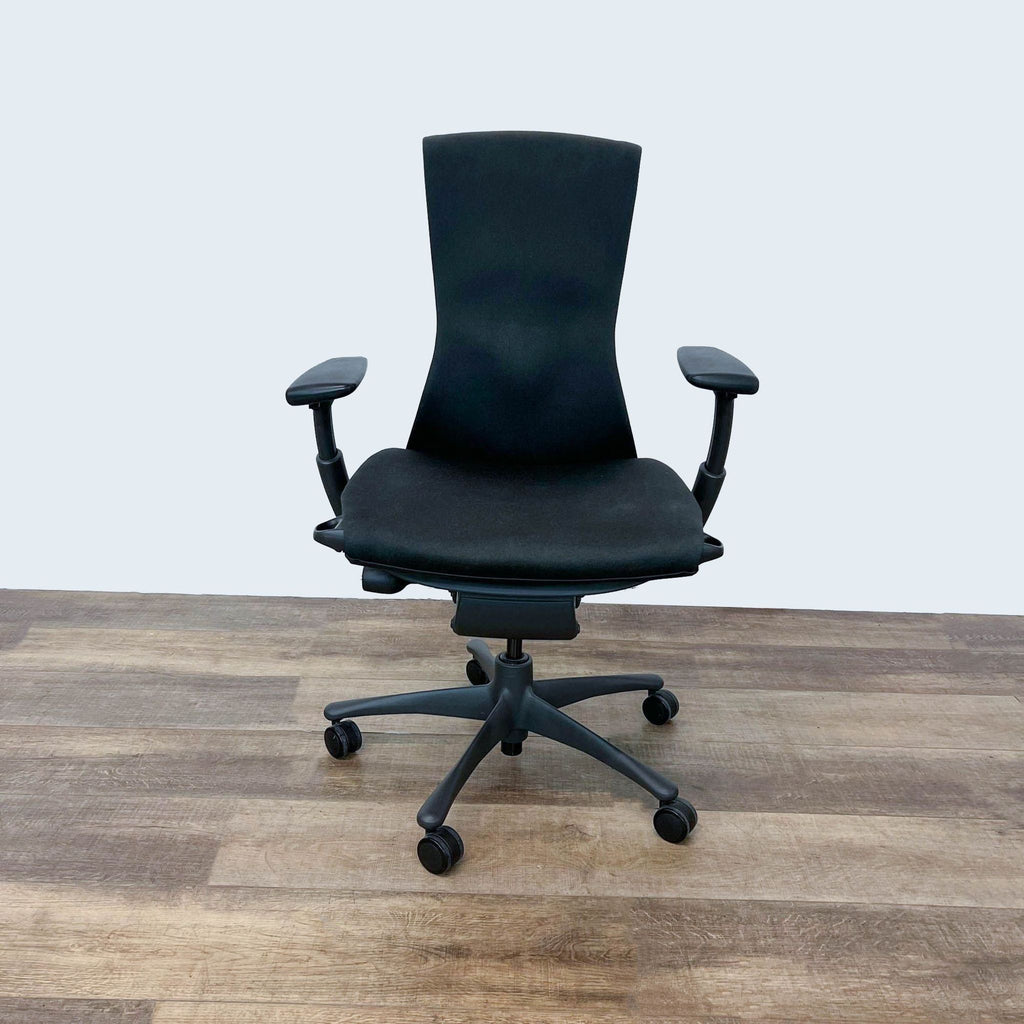 1. Herman Miller Embody Task Chair in black with Pixelated Support system, showcasing ergonomic design and a narrow back on a wooden floor.