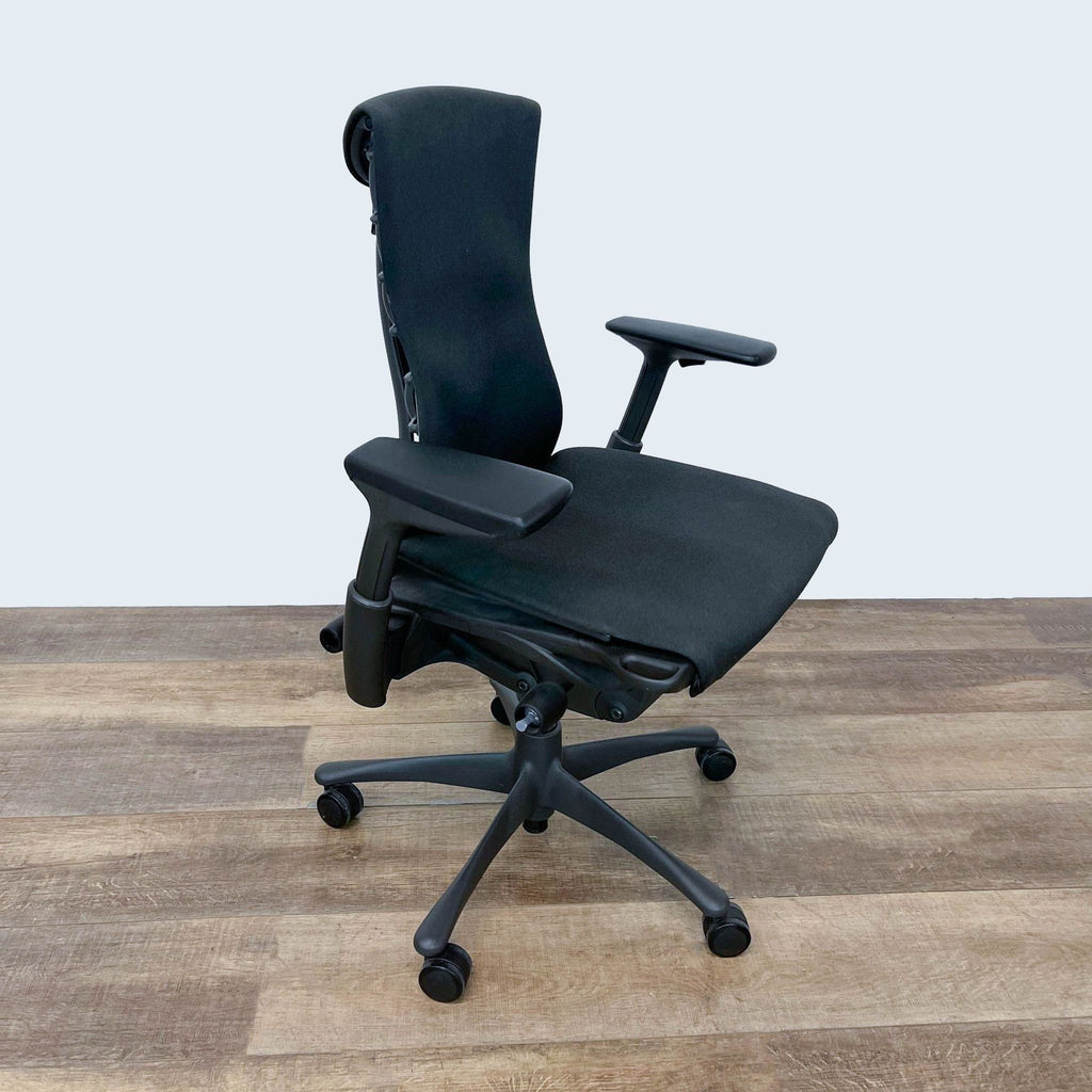 2. Side view of a Herman Miller Embody Chair, highlighting the side profile and adjustment mechanisms with a focus on posture support.