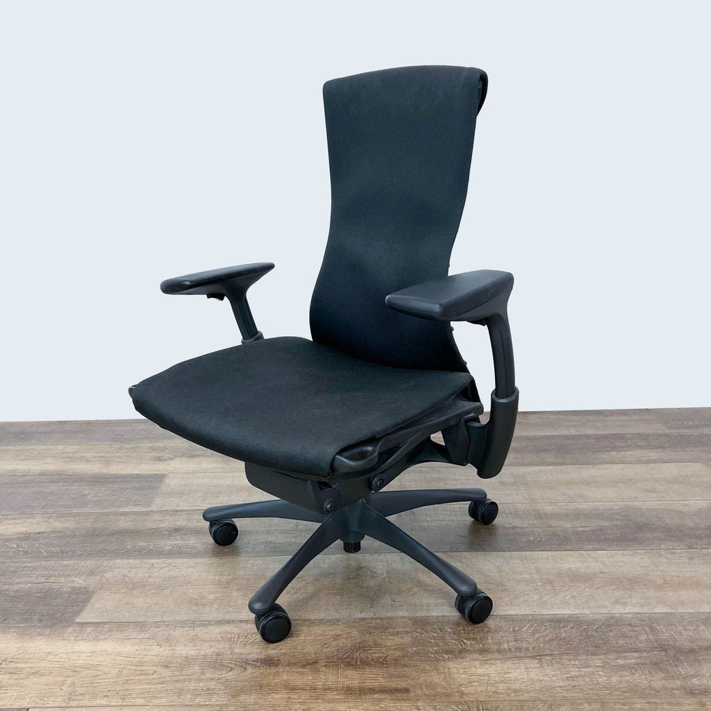 3. Herman Miller's Embody Task Chair poised to offer a balance of comfort and freedom of movement, featuring adjustable armrests and a contoured backrest.