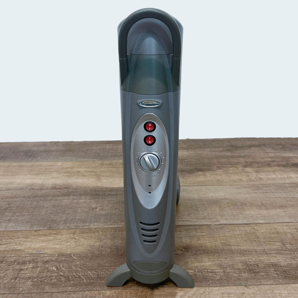 Portable Bionaire Electric Space Heater with thermostat control, on a wooden floor.