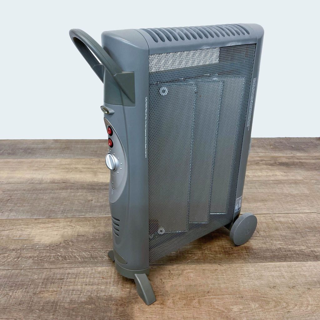 Bionaire Electric Space Heater shown from the side with built-in wheels and safety grill.