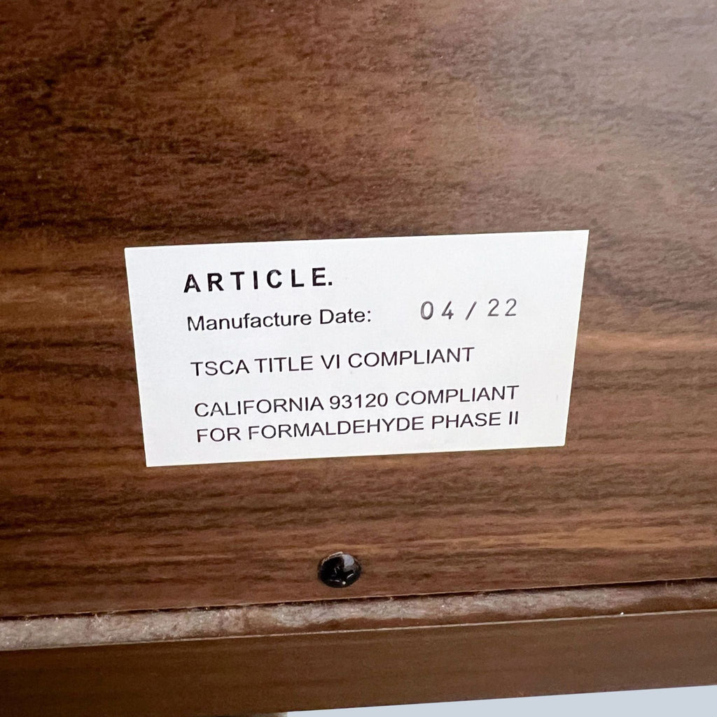 2. "Close-up of a manufacture label on a Nera dresser by Article showing compliance and date details."
