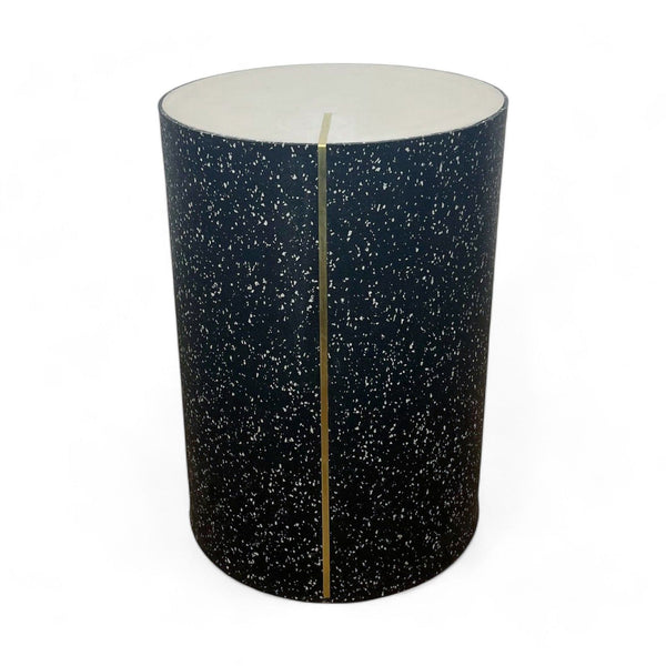 Reperch brand side table with a black terrazzo pattern and a white top.