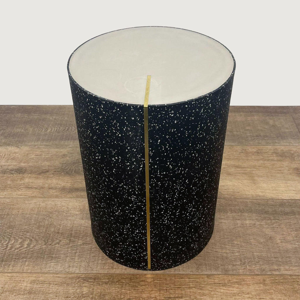 Front view of a Reperch terrazzo patterned console table with a thin gold line.