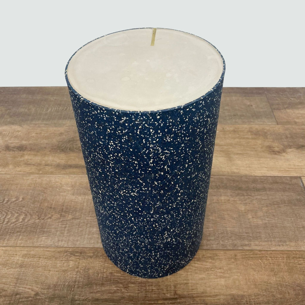Blue terrazzo patterned console table by Reperch, viewed from a top angle on a hardwood surface.