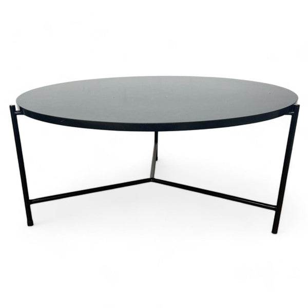 Croft House handcrafted coffee table with black granite top and three-legged matte black steel base.