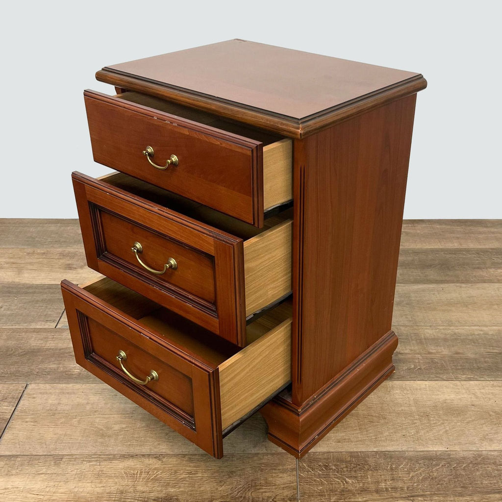 Open drawer view of a Reperch wooden end table, showcasing storage capacity on a wood floor.