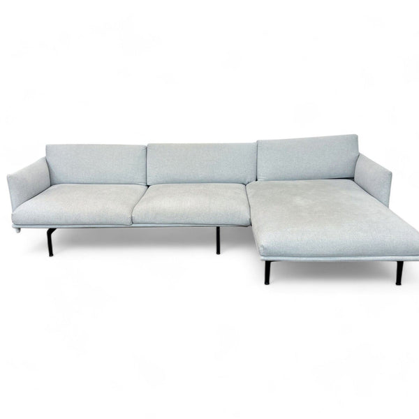 Light gray Design Within Reach sectional sofa against a white background, modern style.