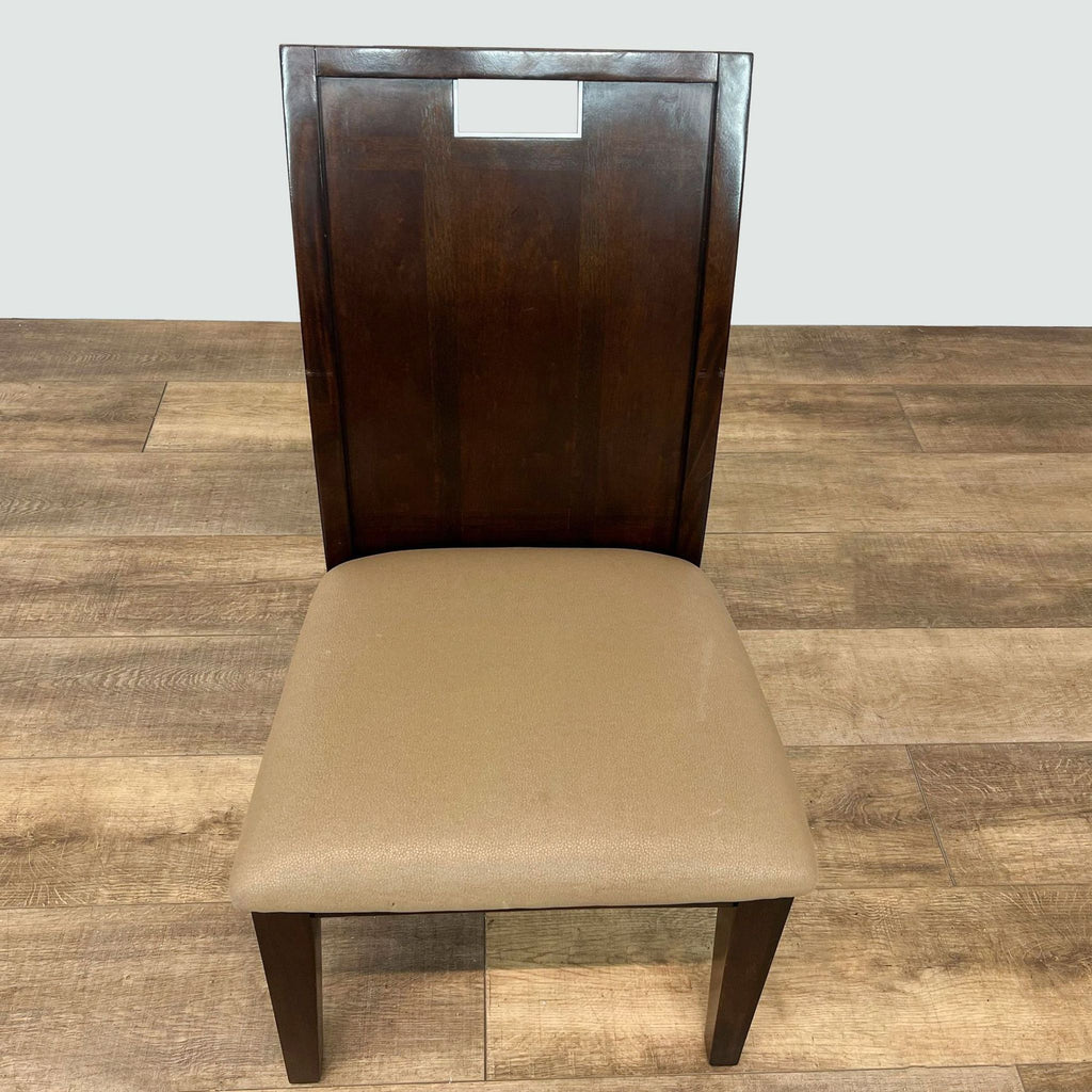 Dining chair from Acme Furniture with dark wooden backrest and tan upholstery, presented on a hardwood floor.