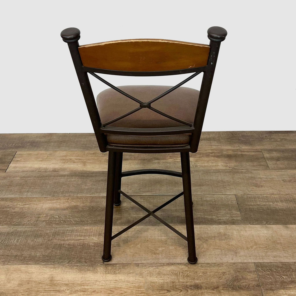 Metal frame stool by Reperch with a crisscross back design and wood accent on top.