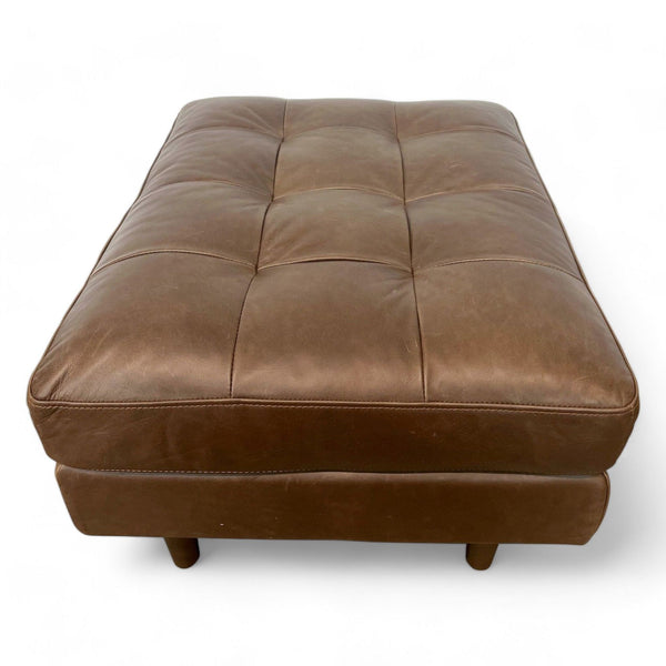 1. Brown leather mid-century tufted ottoman by Article, rectangular with wood feet, against a white background.