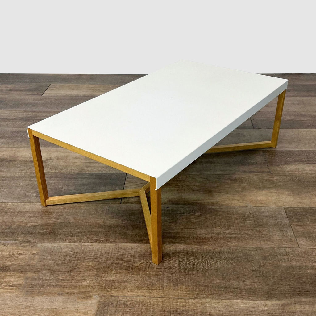 Wood-base coffee table by EQ3 with a minimalist design placed on wooden flooring.