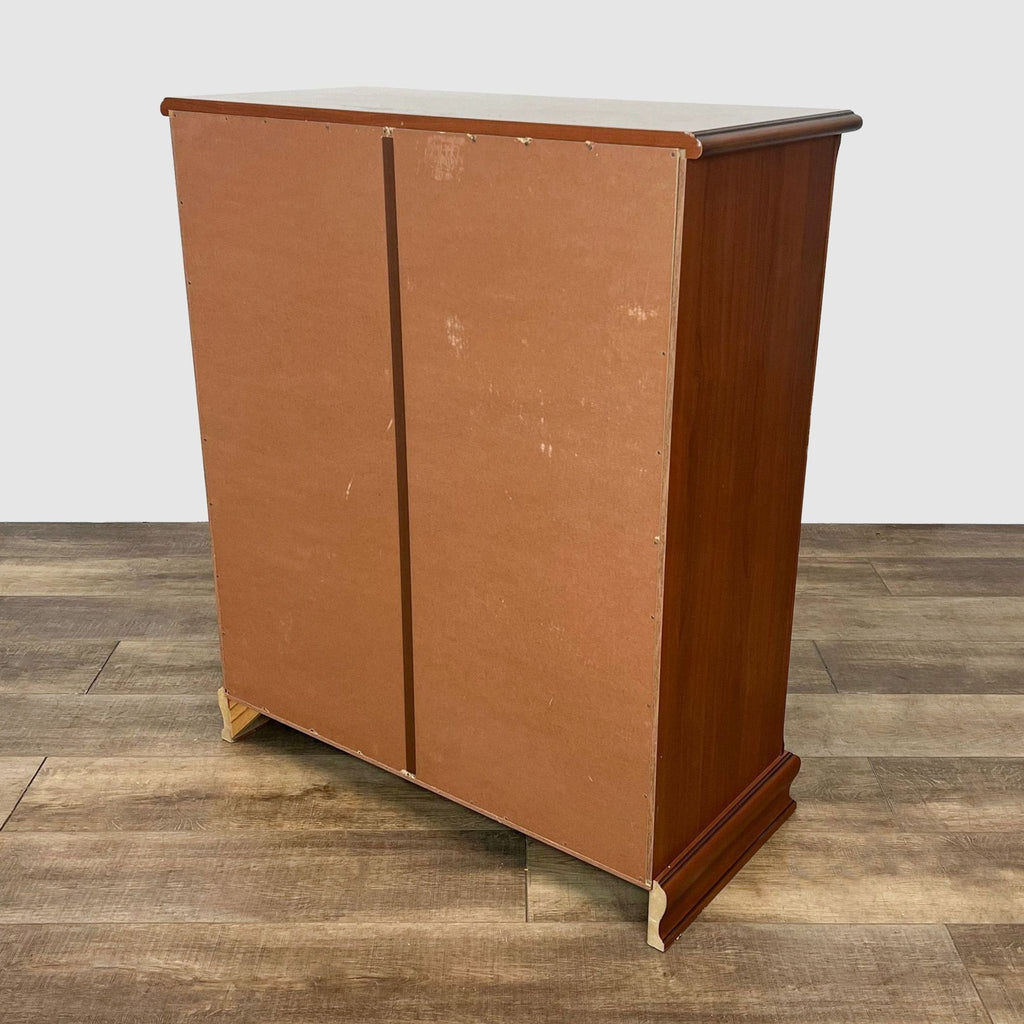 Back view of a Reperch wooden dresser with a visible cardboard backing and mahogany finish.