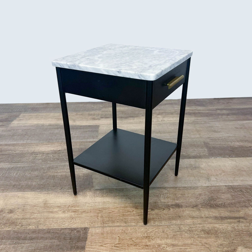 Contemporary West Elm table with marble top, closed drawer, and sleek black frame.