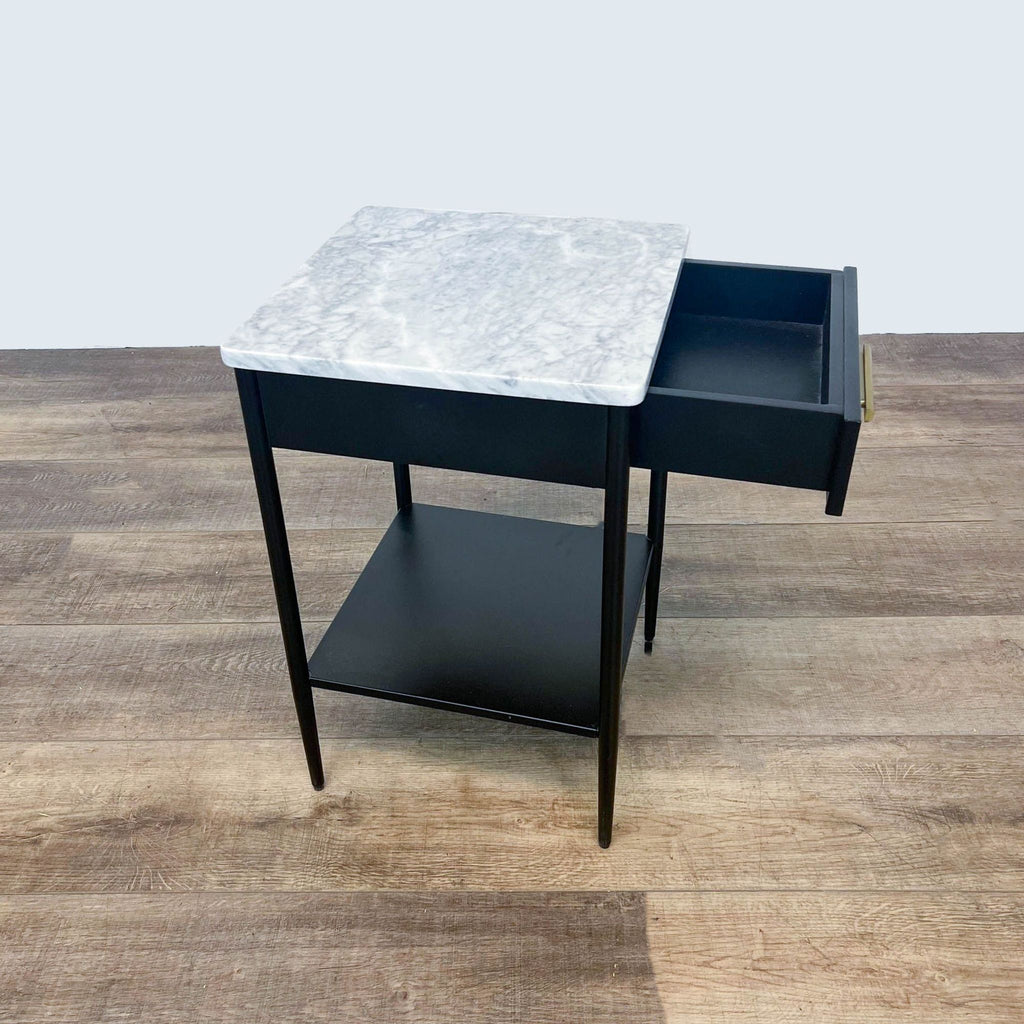 West Elm end table featuring a marble surface, open black drawer, and lower shelf.