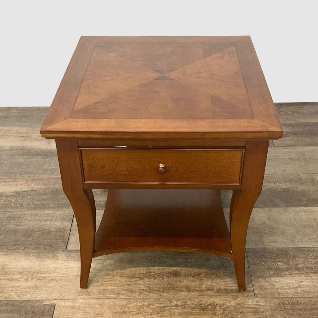 Elegant Thomasville end table with a detailed inlaid top, curved cabriole legs, and shelf, centered in a well-lit room.
