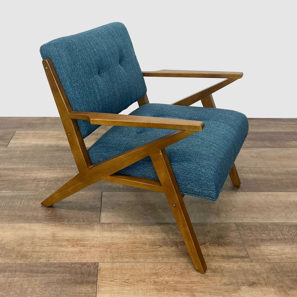 Angled side view of a teal tweed upholstered E&E Co. lounge chair with Mid Century Modern wood design.