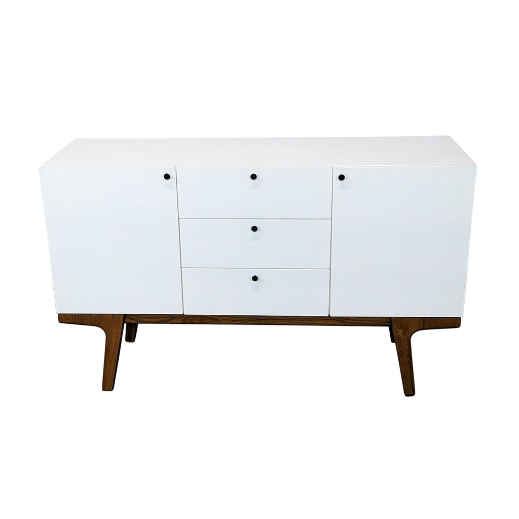 West Elm Scandinavian-style entertainment center with three drawers and solid wood legs, closed view.