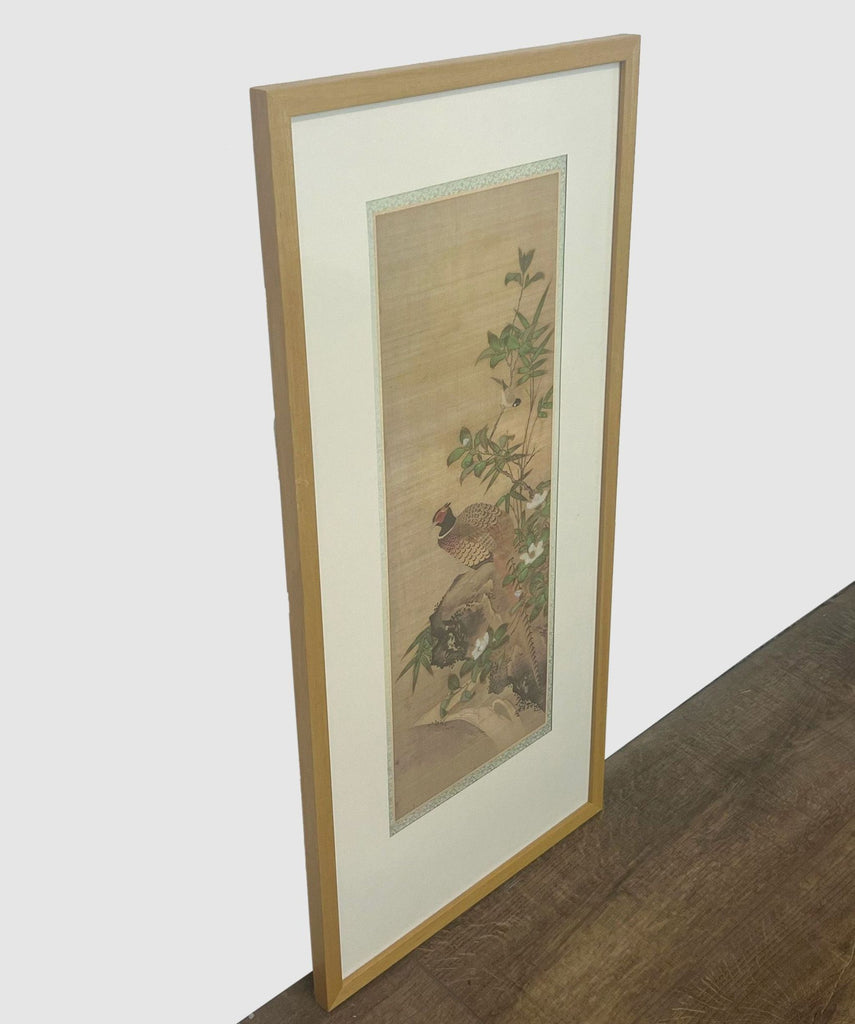 Vertical Reperch Japanese bird and flower art print in a wooden frame leaning against a wall.