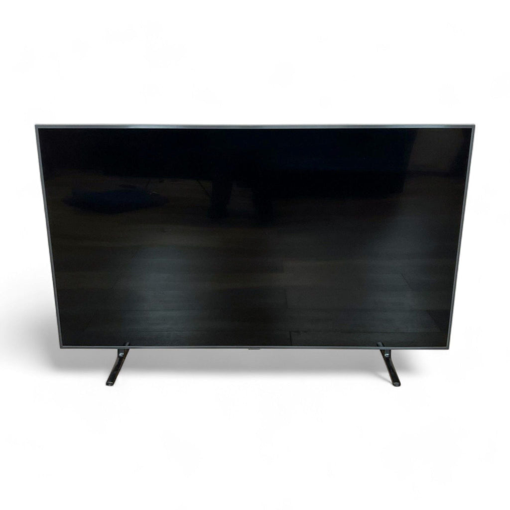 Sleek Samsung HD television on a simple stand displaying a black, blank screen, exemplifying a modern home entertainment addition.