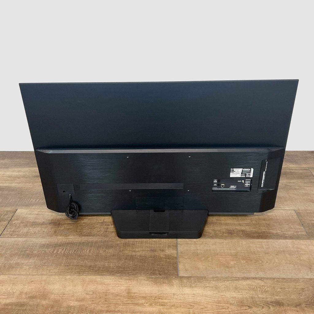 Back view of a sleek LG TV with connection ports visible.