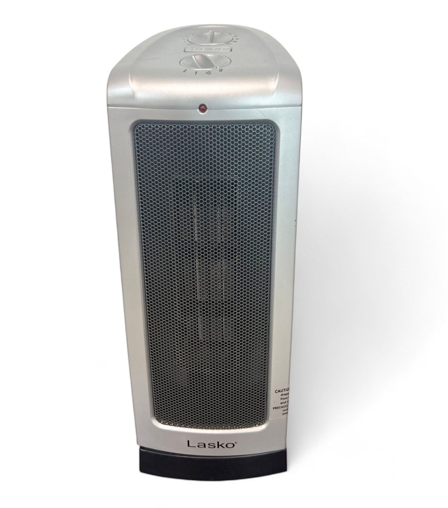 Compact Lasko portable ceramic heater with silver exterior and simple knob controls for heating.