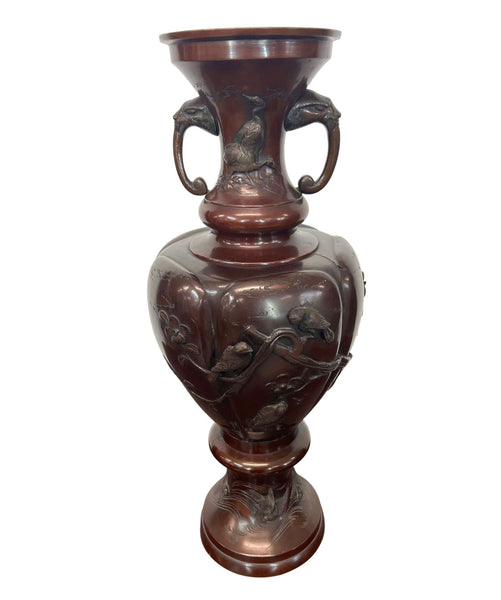 a large chinese bronze vase with a floral design