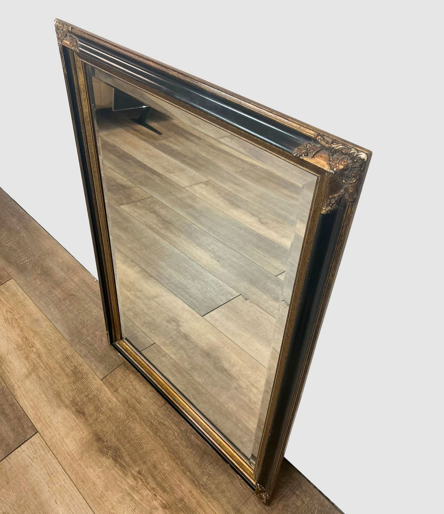 Rectangular mirror by Reperch, ornate corners, bronze and gold tones.