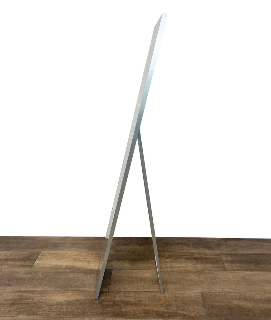 Side view of the Infinity mirror showing its thin frame and easel back support.