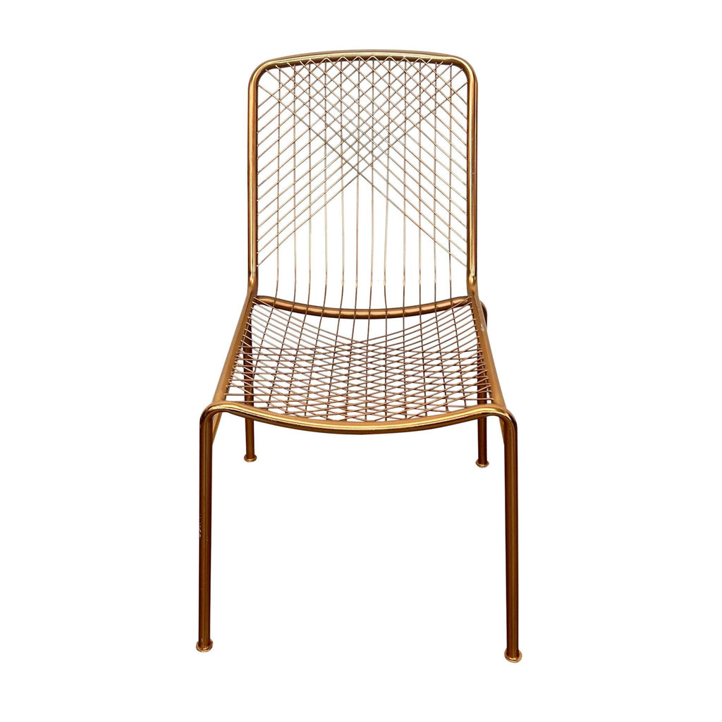 CB2 Modern Beta chair with brass lacquer and handmade iron frame with a woven wire back in a linear design, isolated on white.