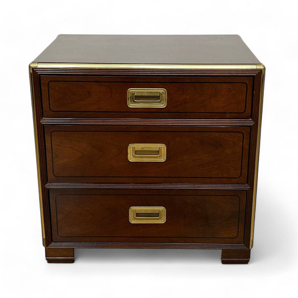 1. Reperch brand end table, a three-drawer nightstand with brass accents, viewed from the front.
